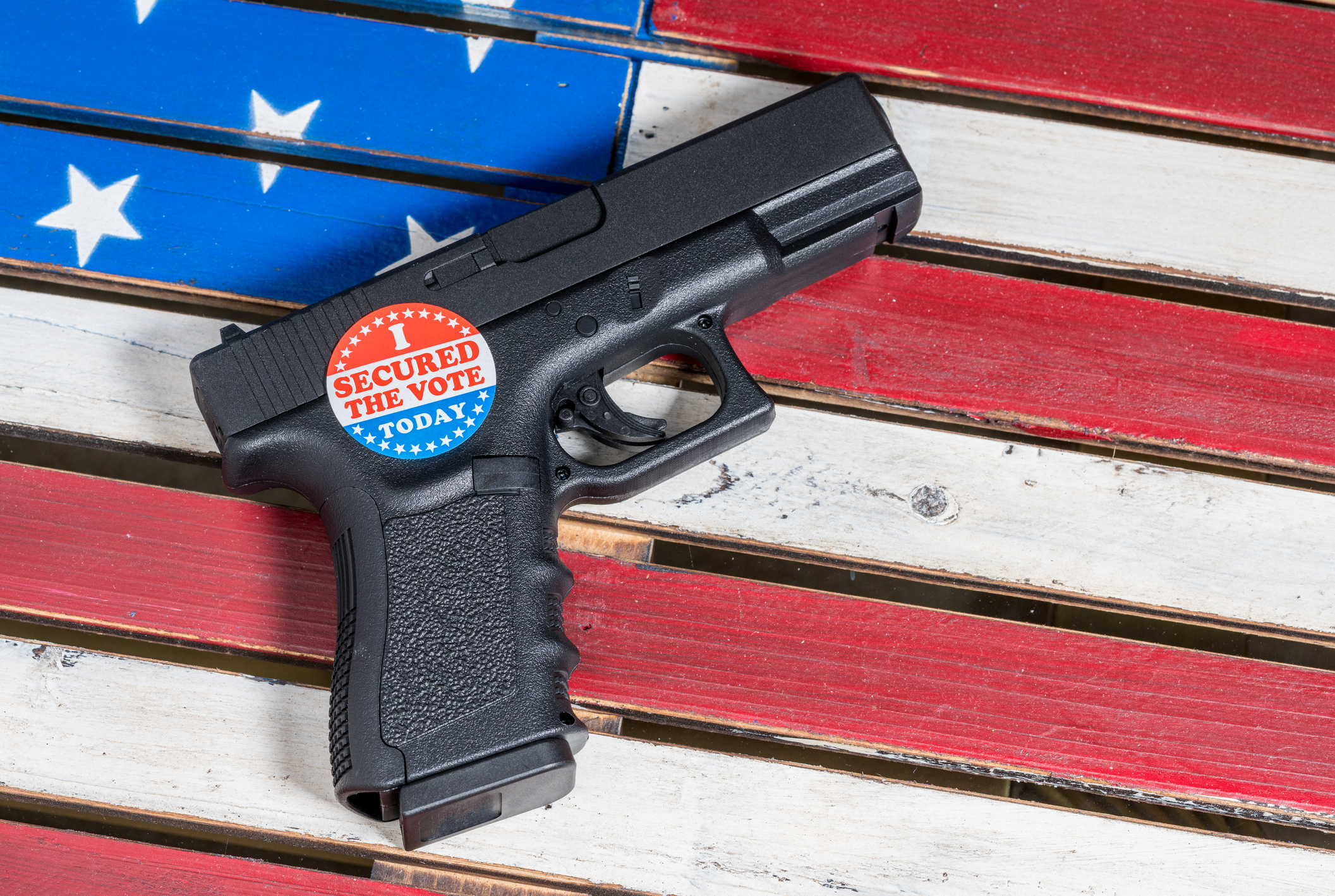 Concept of protecting against voter fraud with firearm and voting sticker