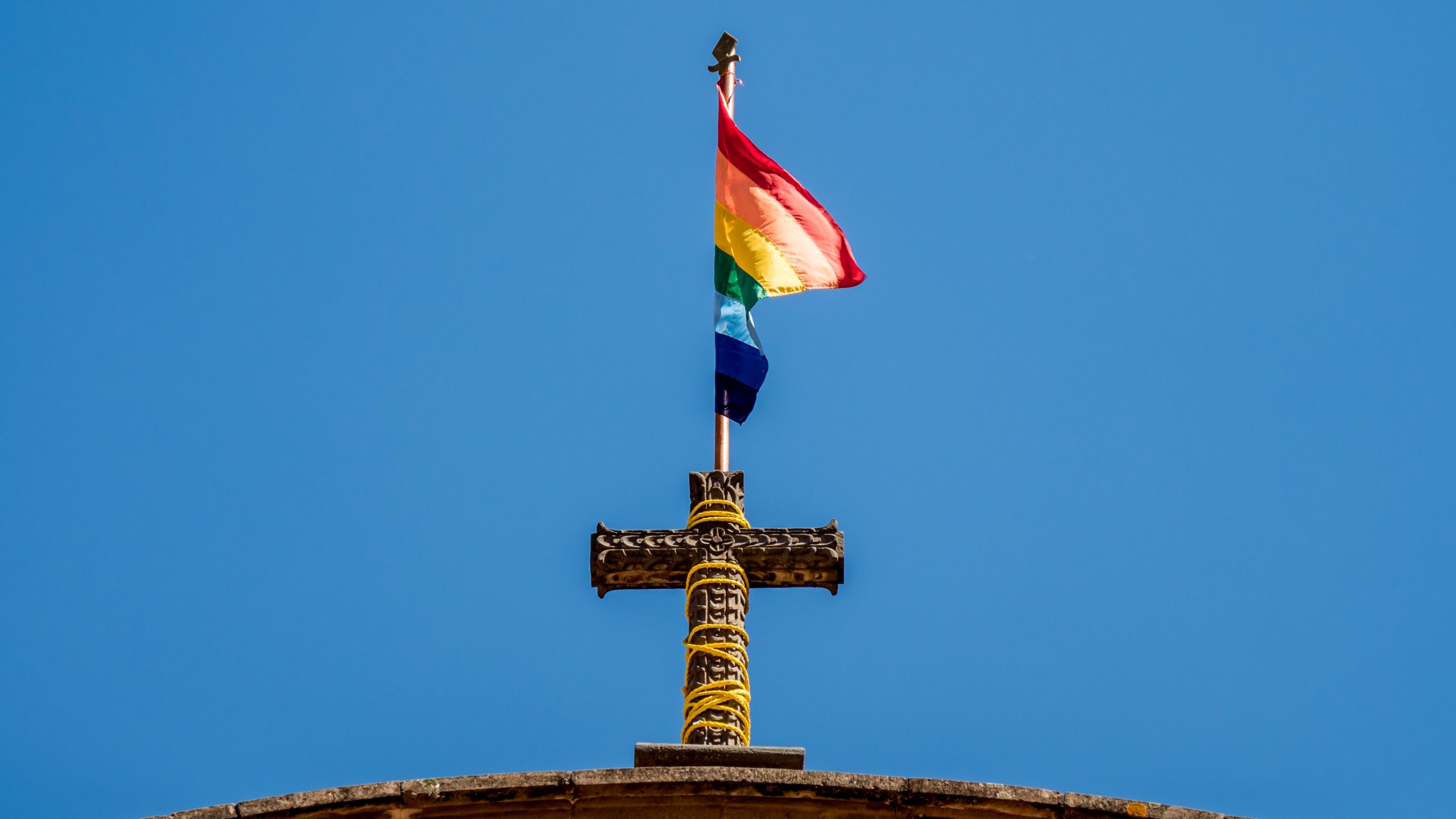 flag of cusco. rainbow flag on top of a church