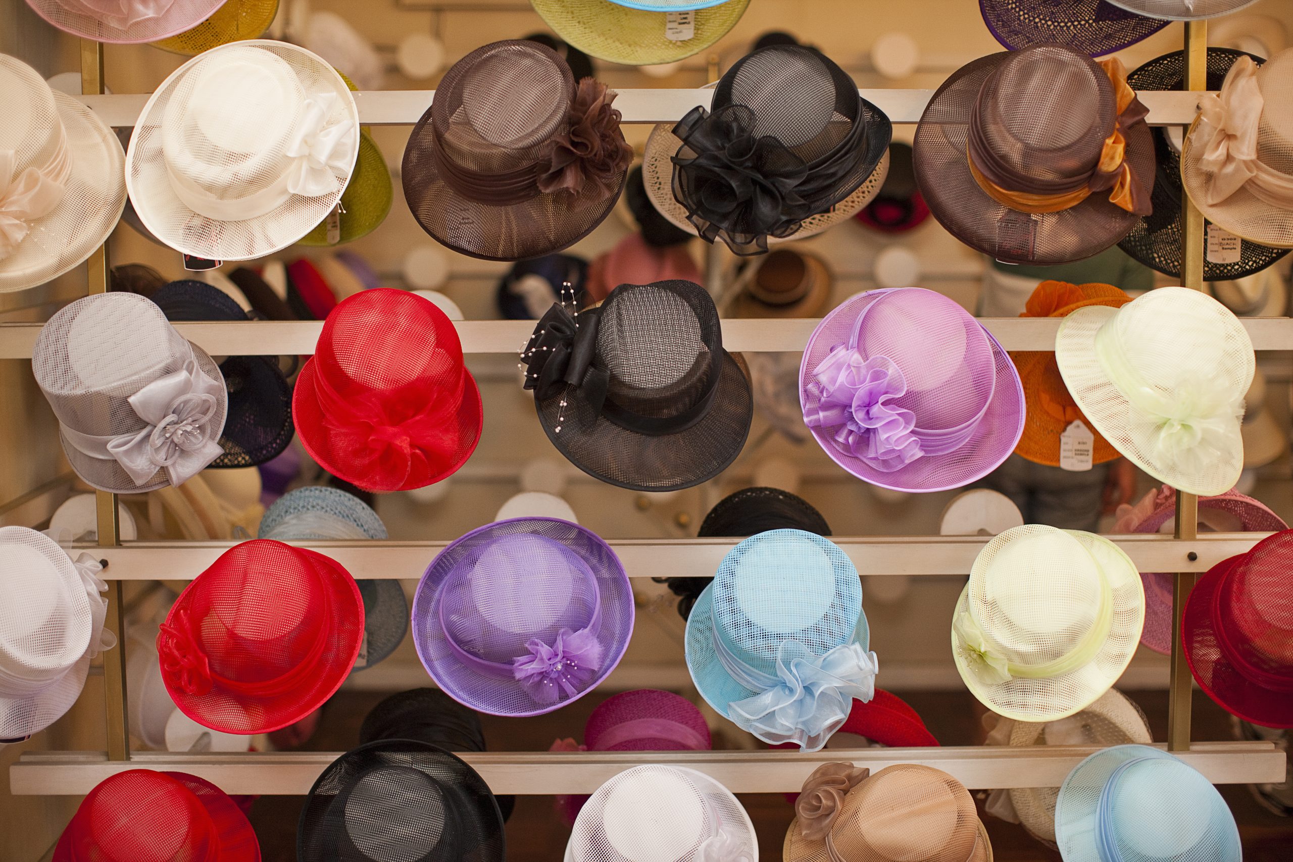 Rows of colorful hats in traditional milliners shop