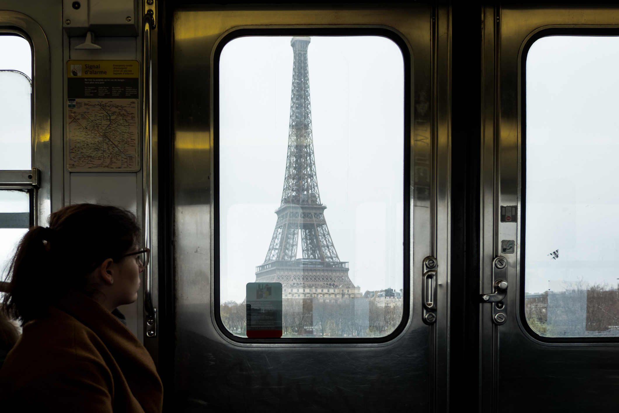 Woman Looking At Eiffel Tower Through Train Window