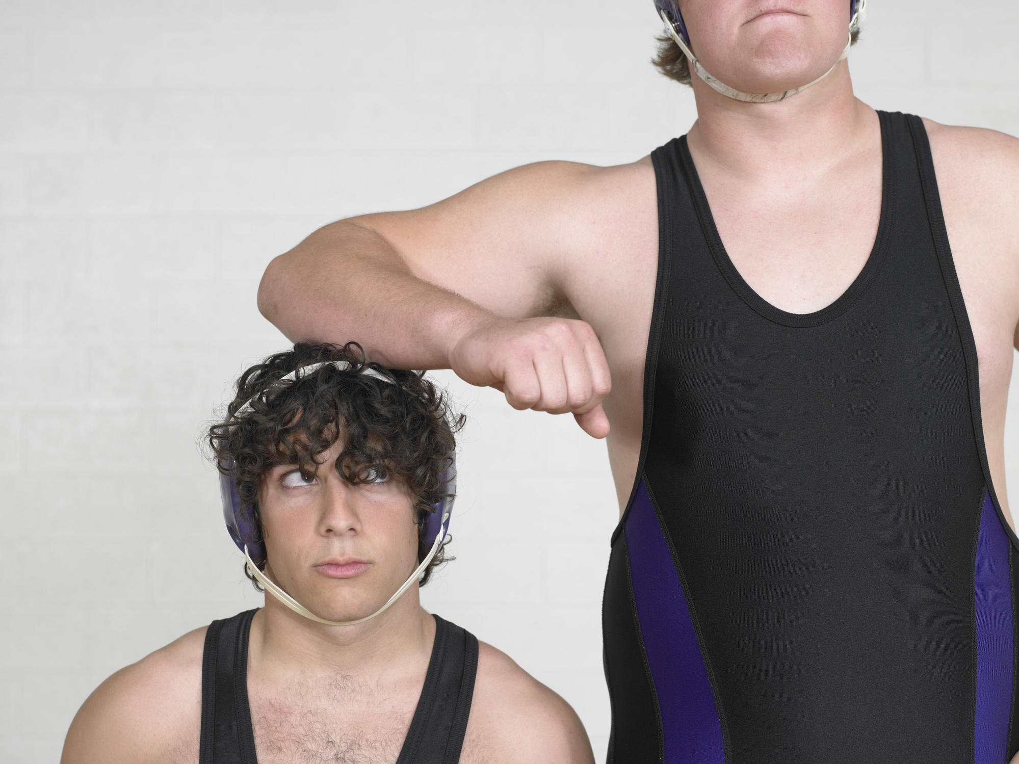 Teenage boys (16-18) wrestler, leaning on short boy