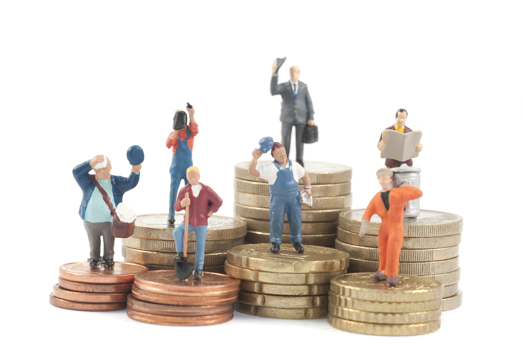 Miniature business people on stacks of coins