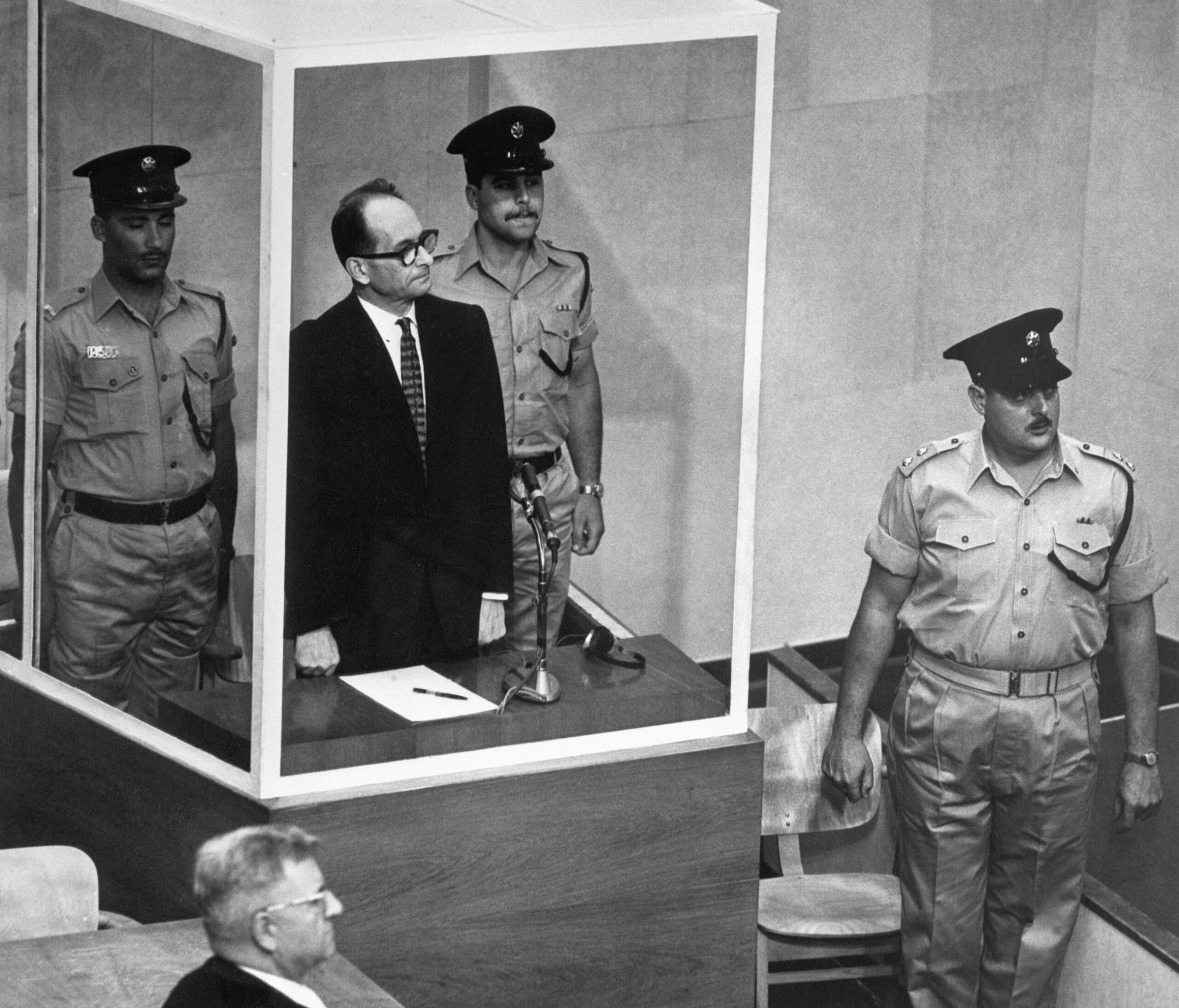 Adolf Eichmann Stands with Israeli Police During Trial