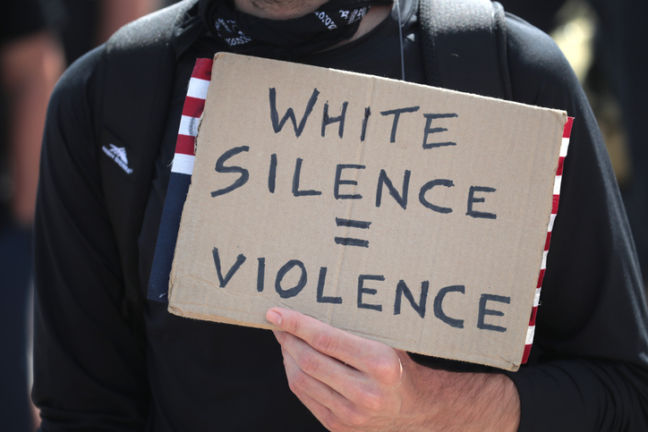 Protestor holds sign at march and rally to protest police violence