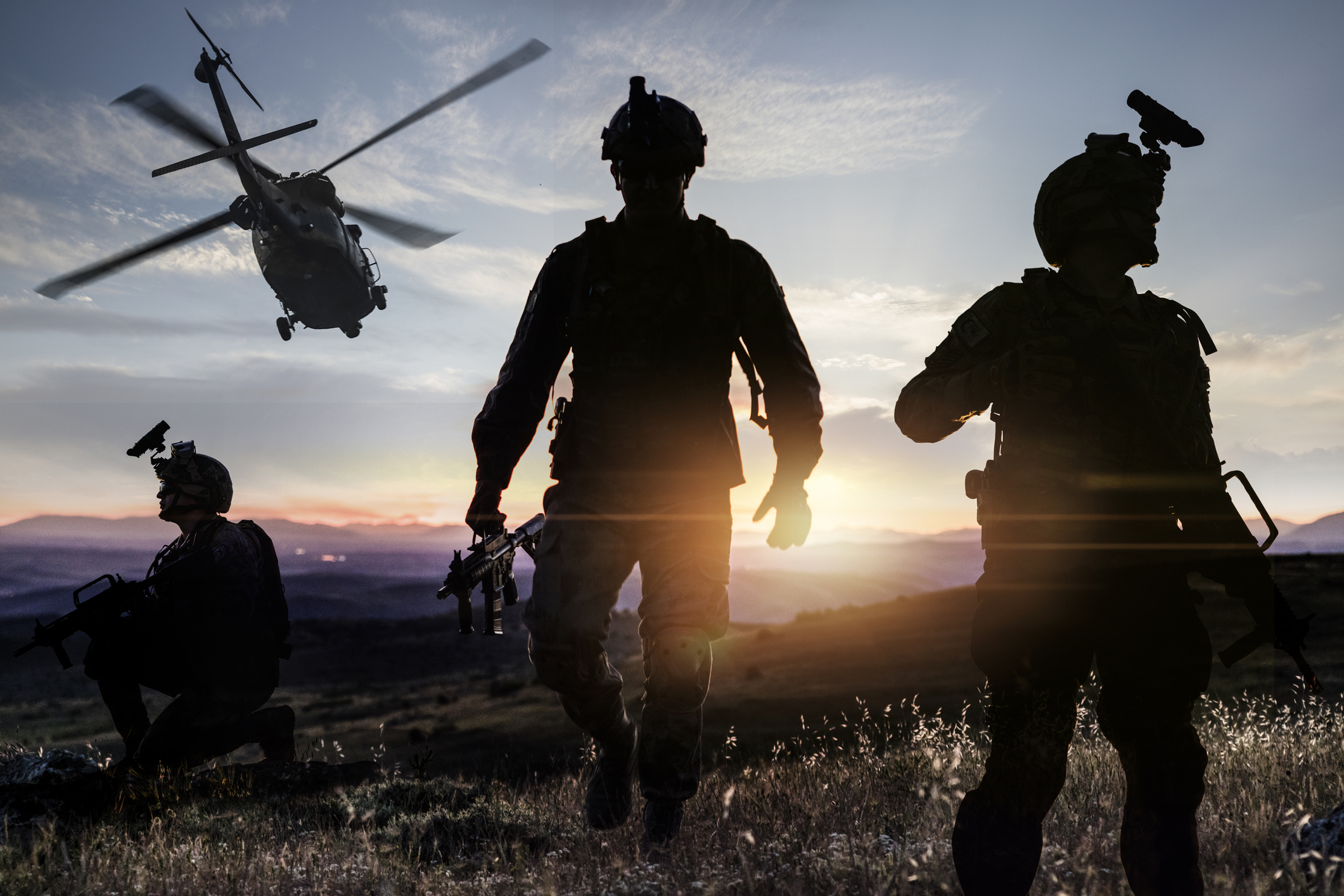 Silhouettes of soldiers during Military Mission  at Sunset