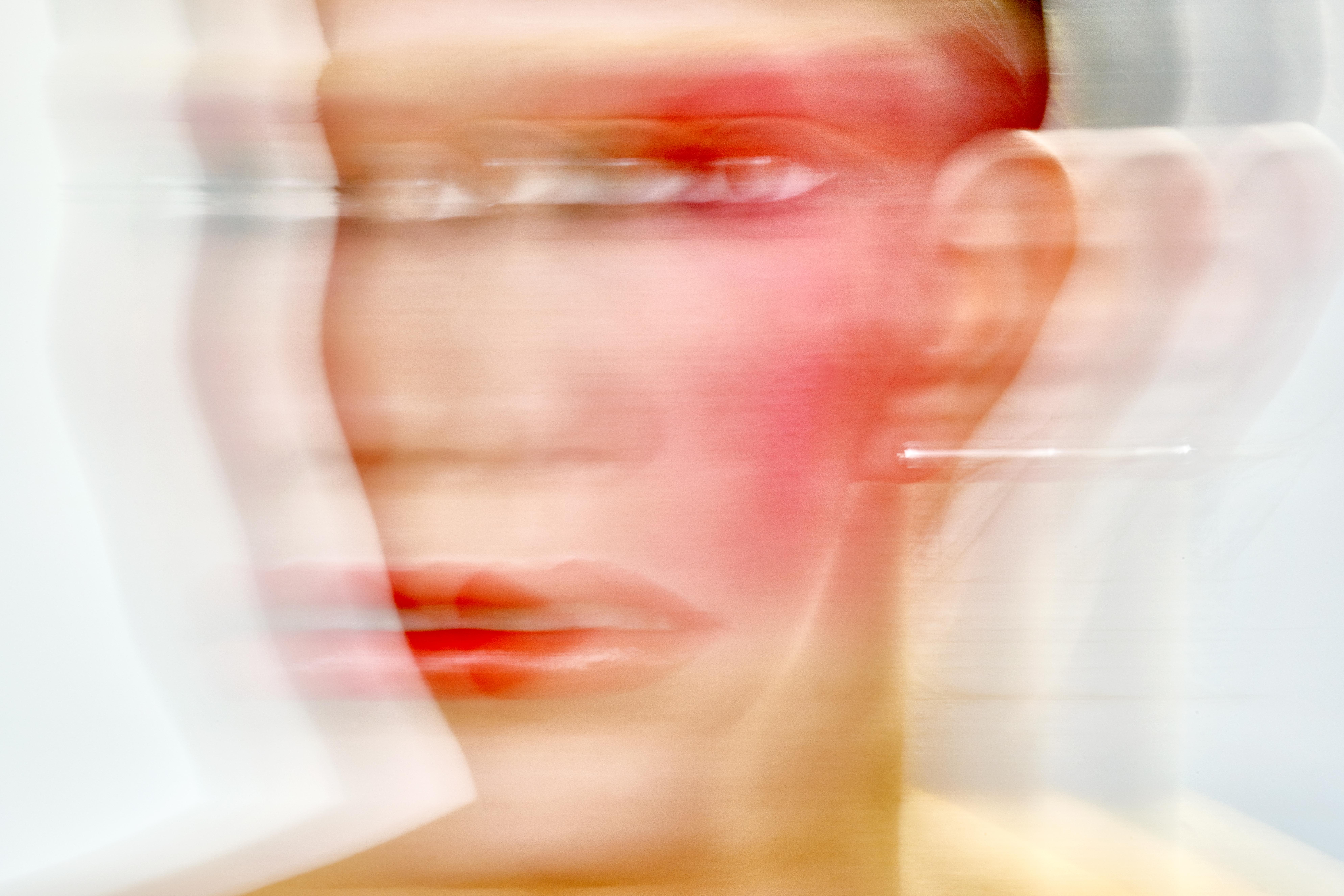 A blurred image of a young woman’s face