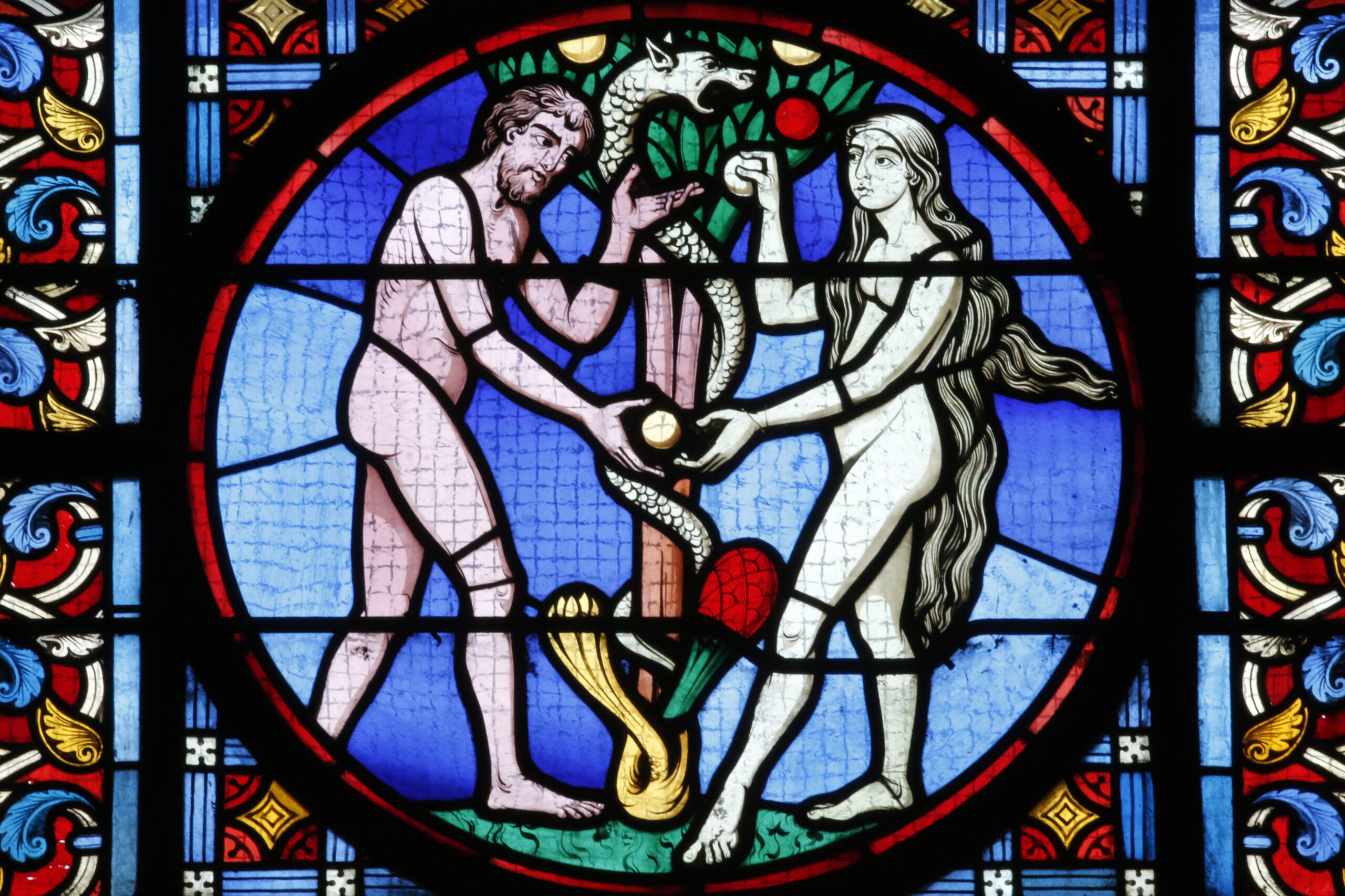 Sacred Heart Basilica, Paray-le-Monial. Stained glass window. Adam and Eve.