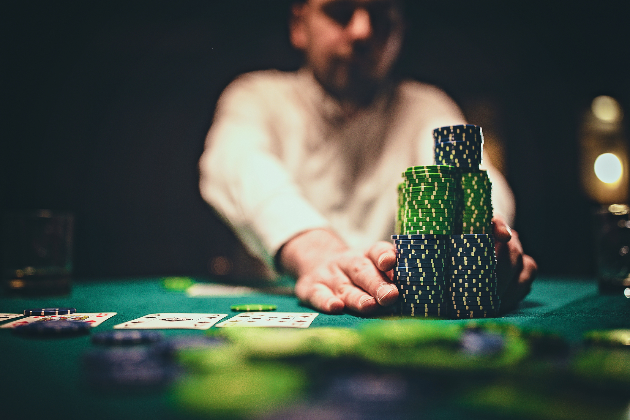 Man playing poker in dark room at night