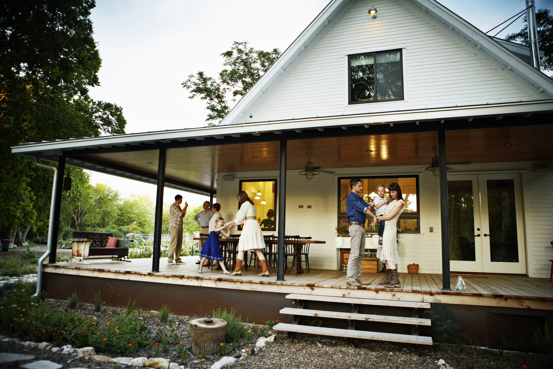 Family on porch after dinner at twilight