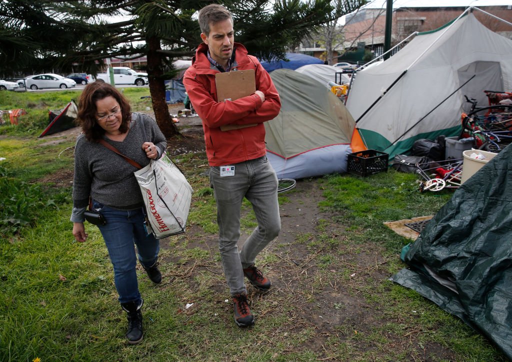 ( l to r ) Wilma Lozada, outreach team member and  Dr. Colin Buzza during a visit to a homeless encampment near Lake Merritt in Oakland, Calif., on Thurs. Mar.1, 2018. Alameda County Health Services has just launched a new street medicine program in which