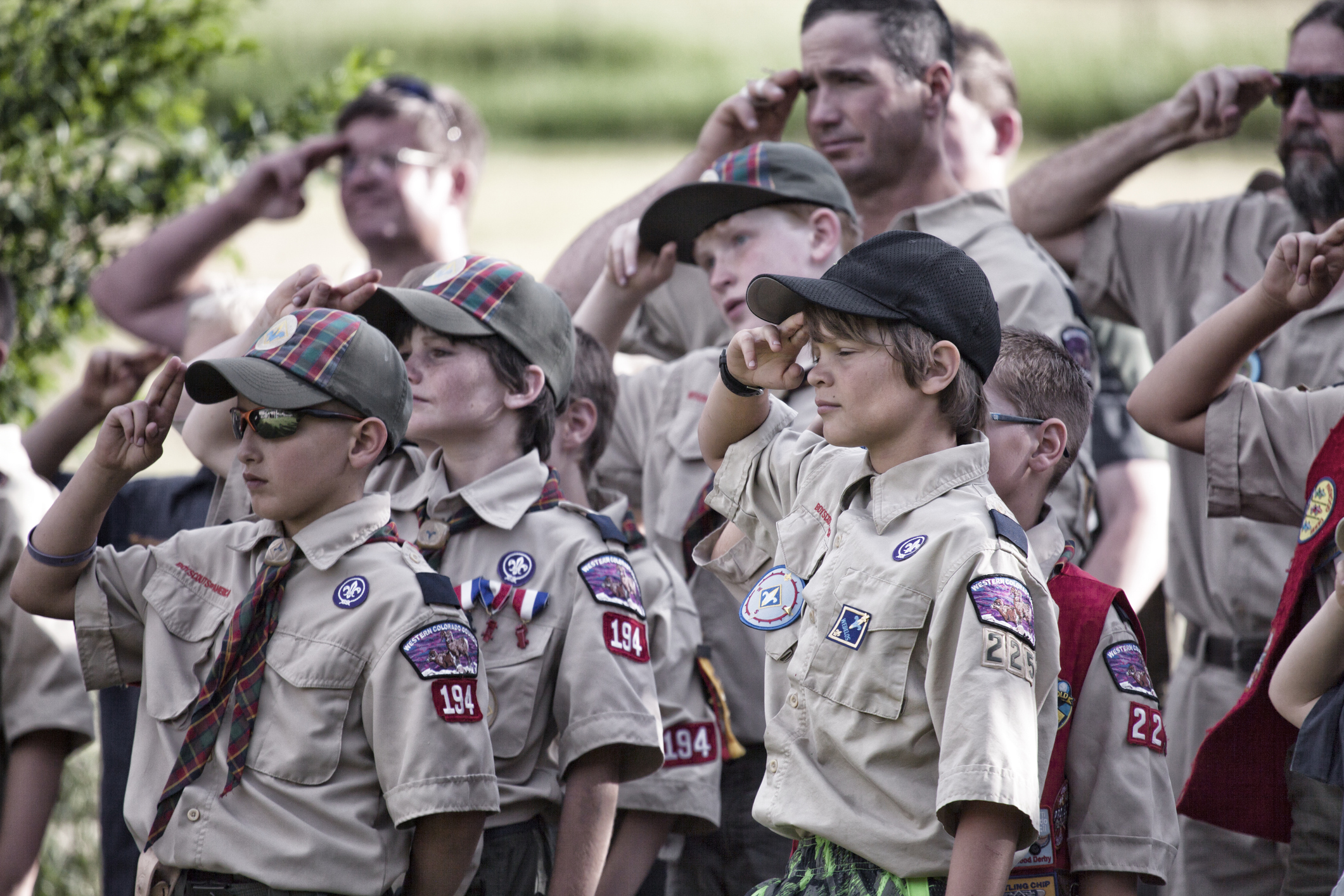 A troop of young, Weblo Boy Scouts salute during an America flag ceremony at their camp in Colorado.