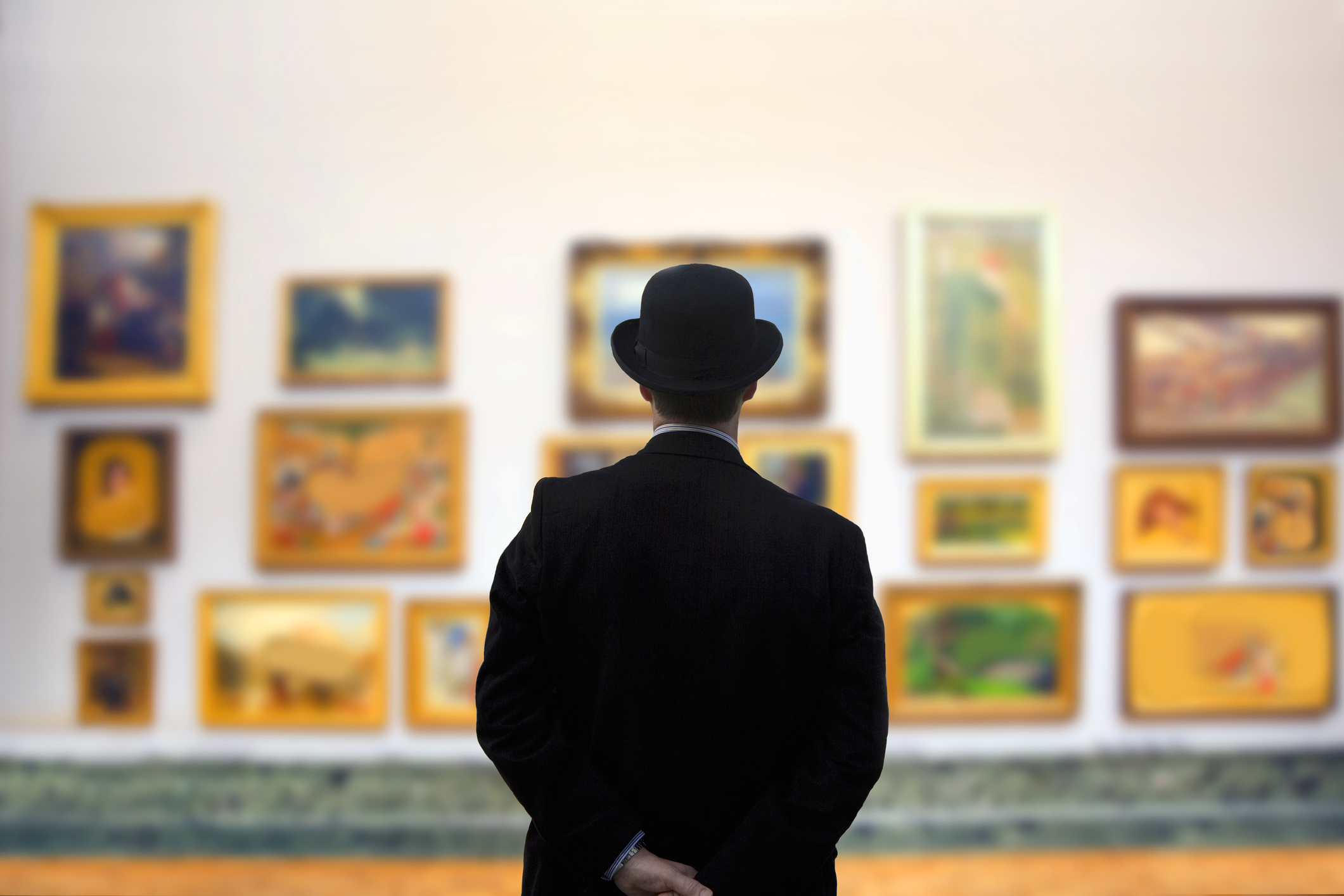 Man wearing Bowler hat in gallery