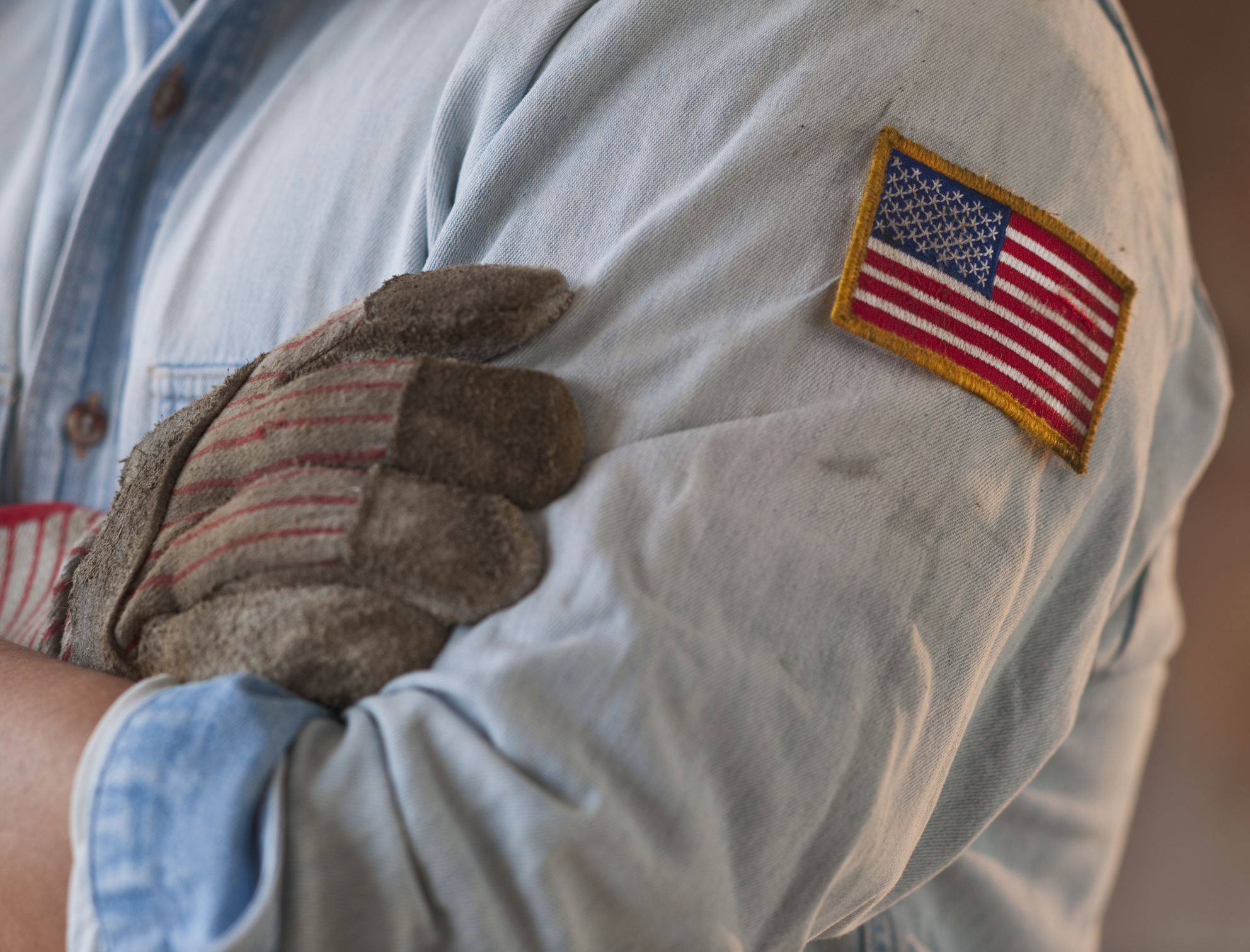 Blue collar working wearing American flag patch