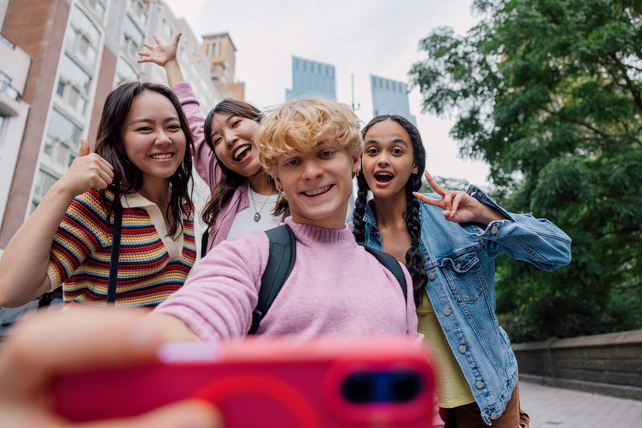 Happy group of students socializing outdoors in a bustling in Midtown Manhattan