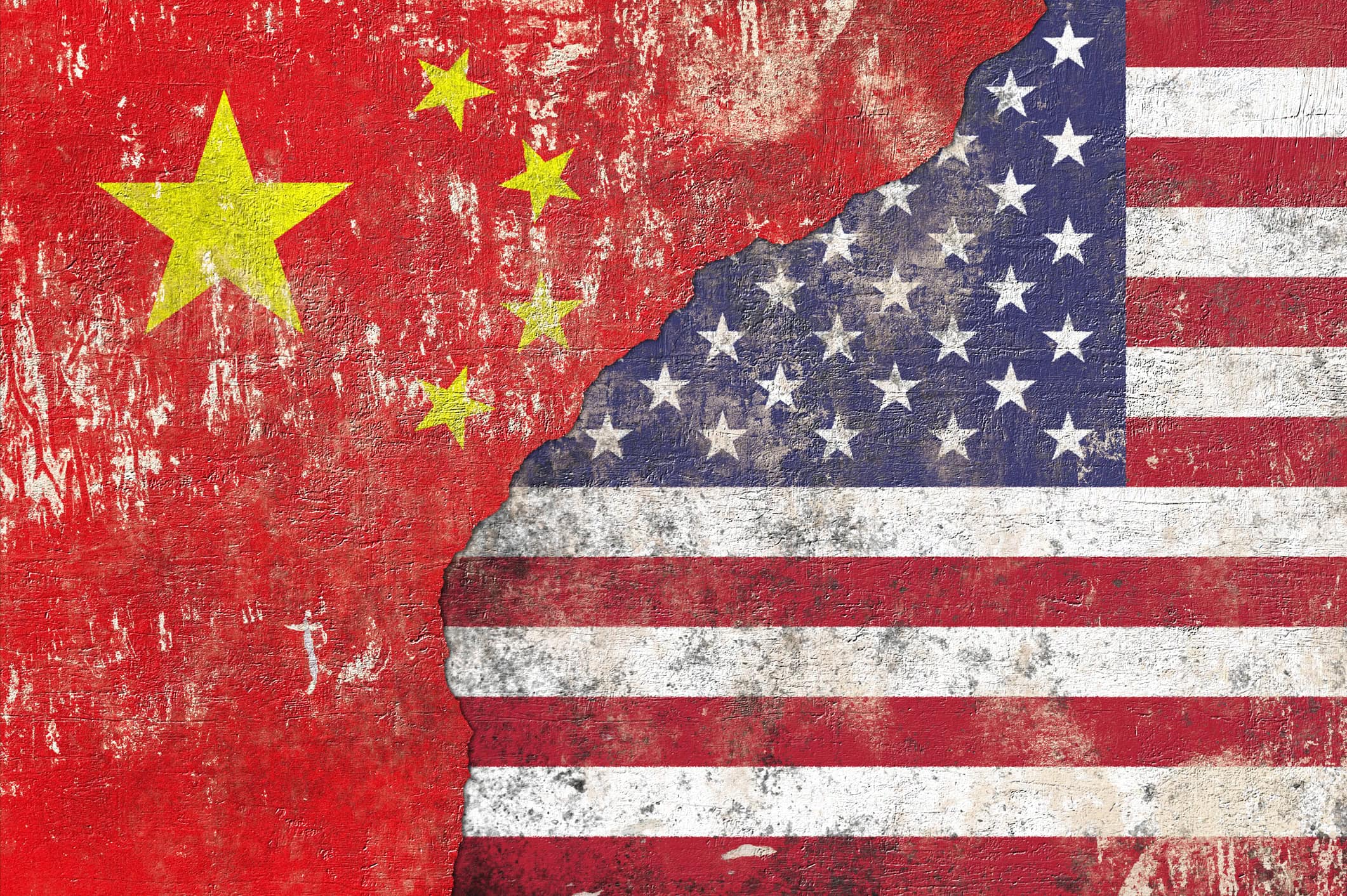 Chinese and USA flag on textured wall background