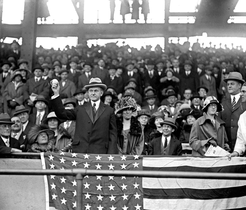 President Calvin Coolidge throwing out the first ball at an opening day ball game ca. 1924