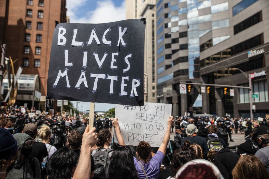 A protester holds a placard that says Black Lives Matter
